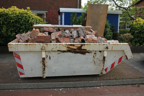 Construction site with builders managing waste clearance